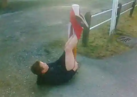 Boy With Shorts Hooked Over Pole