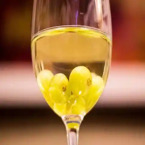 Chill the wine with frozen white grapes